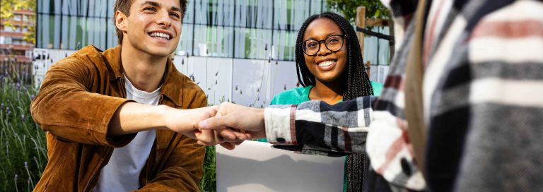 two-happy-male-college-students-fist-bumping-each-2025-01-10-03-12-57-utc